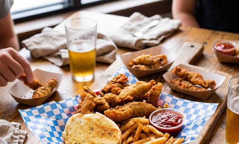 Classic Idaho finger steaks in a basket with fries and dipping sauce